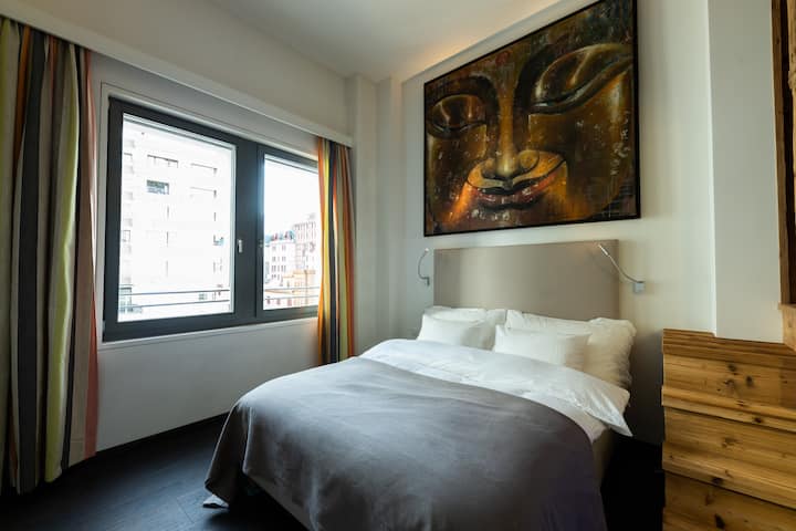 Angelus — bedroom with artwork, daytime
