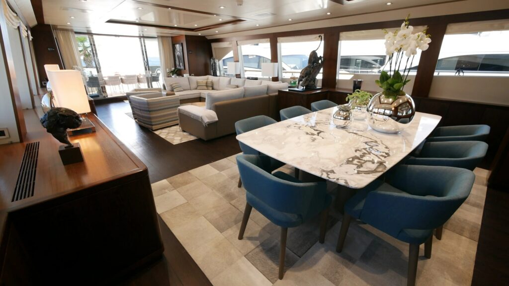 ASCENSION — main salon and marble dining table, charter Côte d'Azur