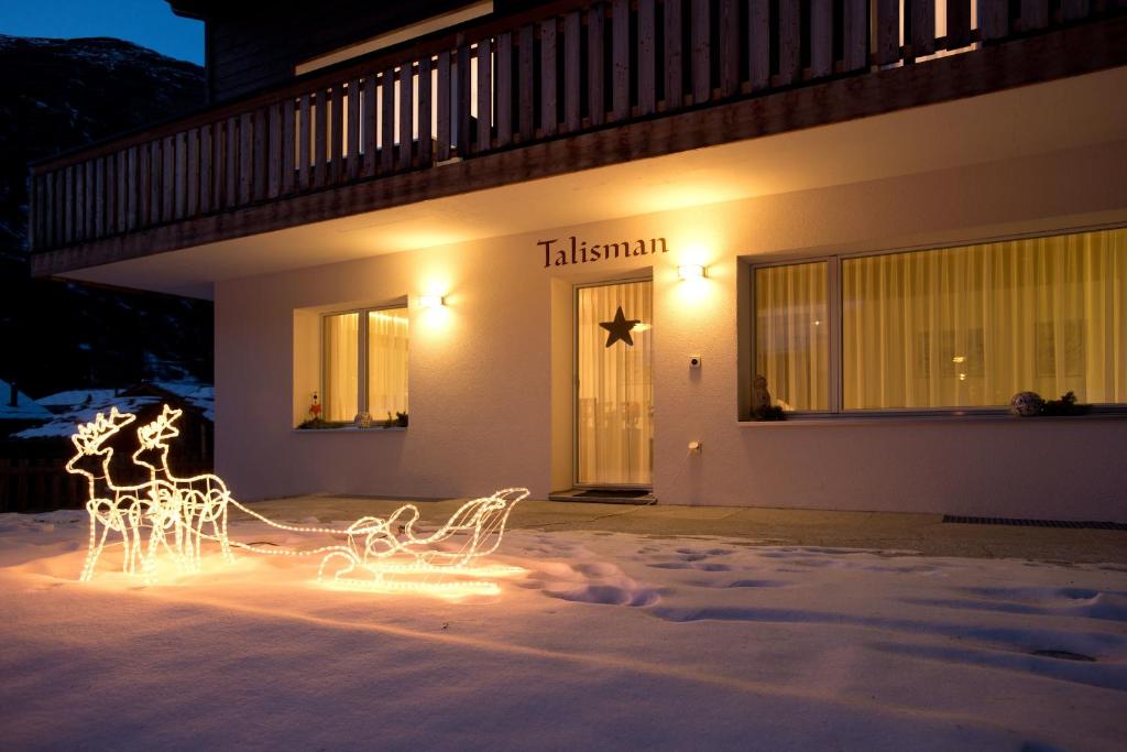 Chalet Talisman, Zermatt — chalet entrance illuminated at night